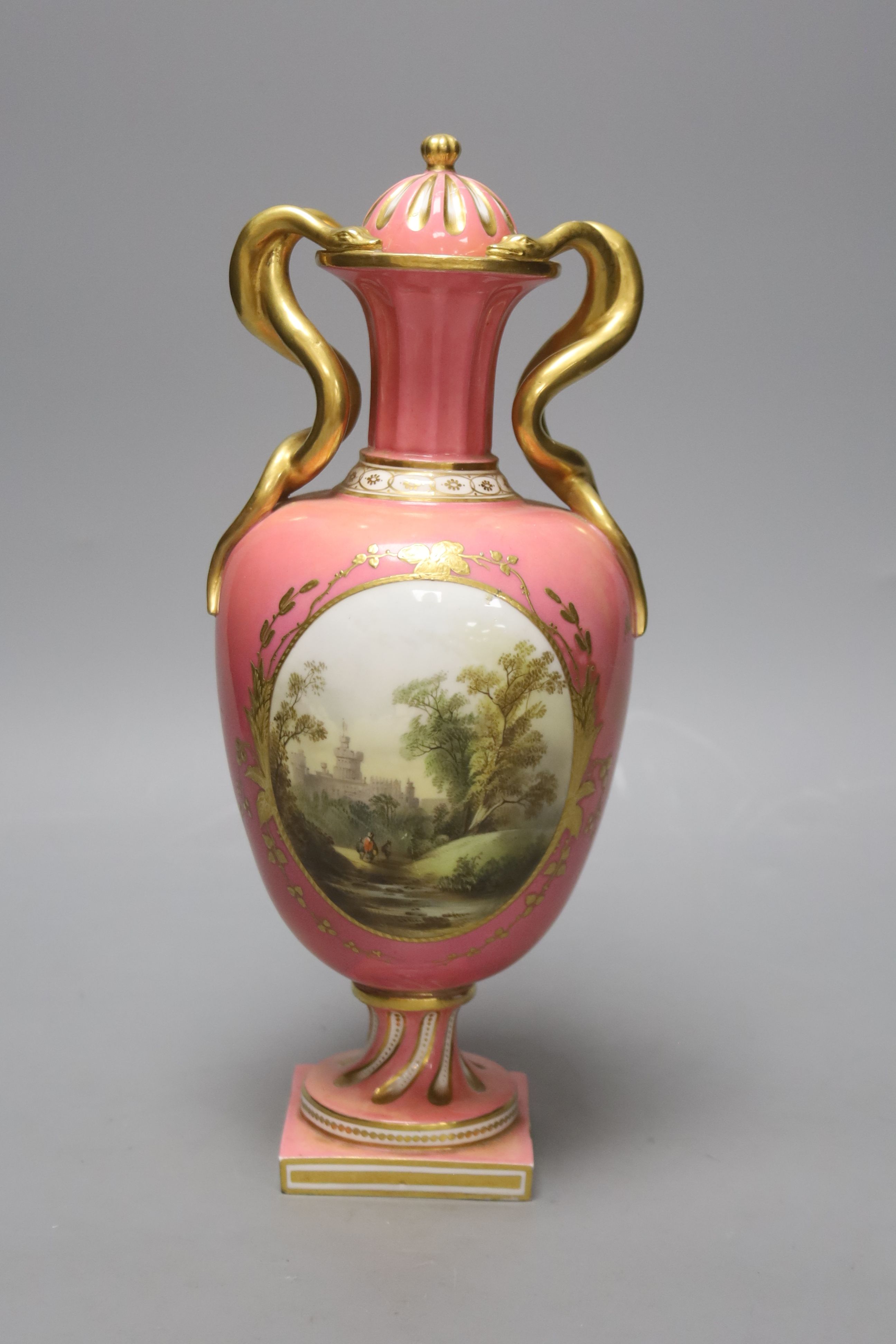 A Coalport pink ground vase and cover, with serpent handle painted with a landscape c.1825, height 29cm